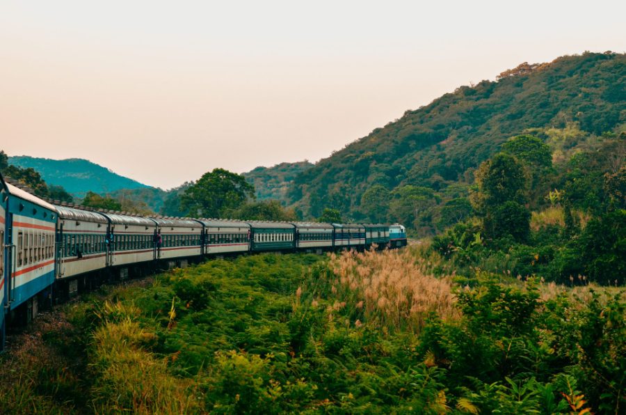 Train traversant les collines boisées au crépuscule
